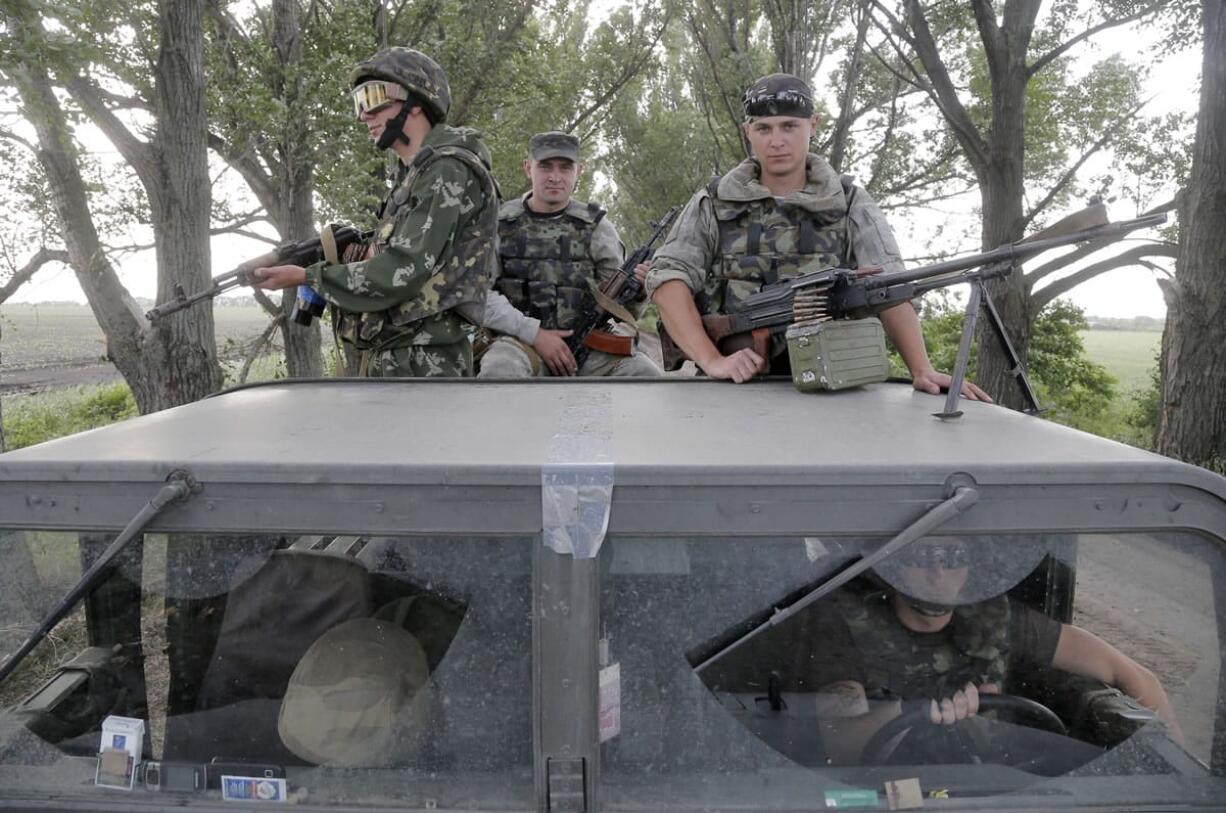 Ukrainian army paratroopers patrol an area after a battle with pro-Russian insurgents close to Slovyansk, Ukraine, on Tuesday.