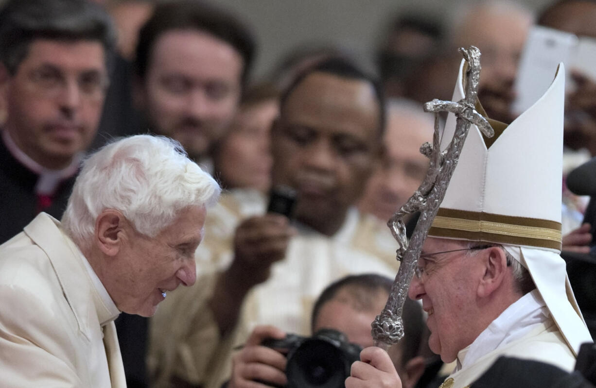 Pope Emeritus Benedict XVI  is greeted Saturday by Pope Francis at the end of a consistory inside St. Peter's Basilica at the Vatican.