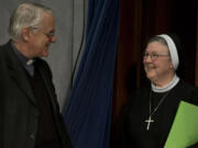 Vatican spokesperson, Father Federico Lombardi, left, greets Mother Mary Clare Millea prior to the start of a press conference at the Vatican on Tuesday.