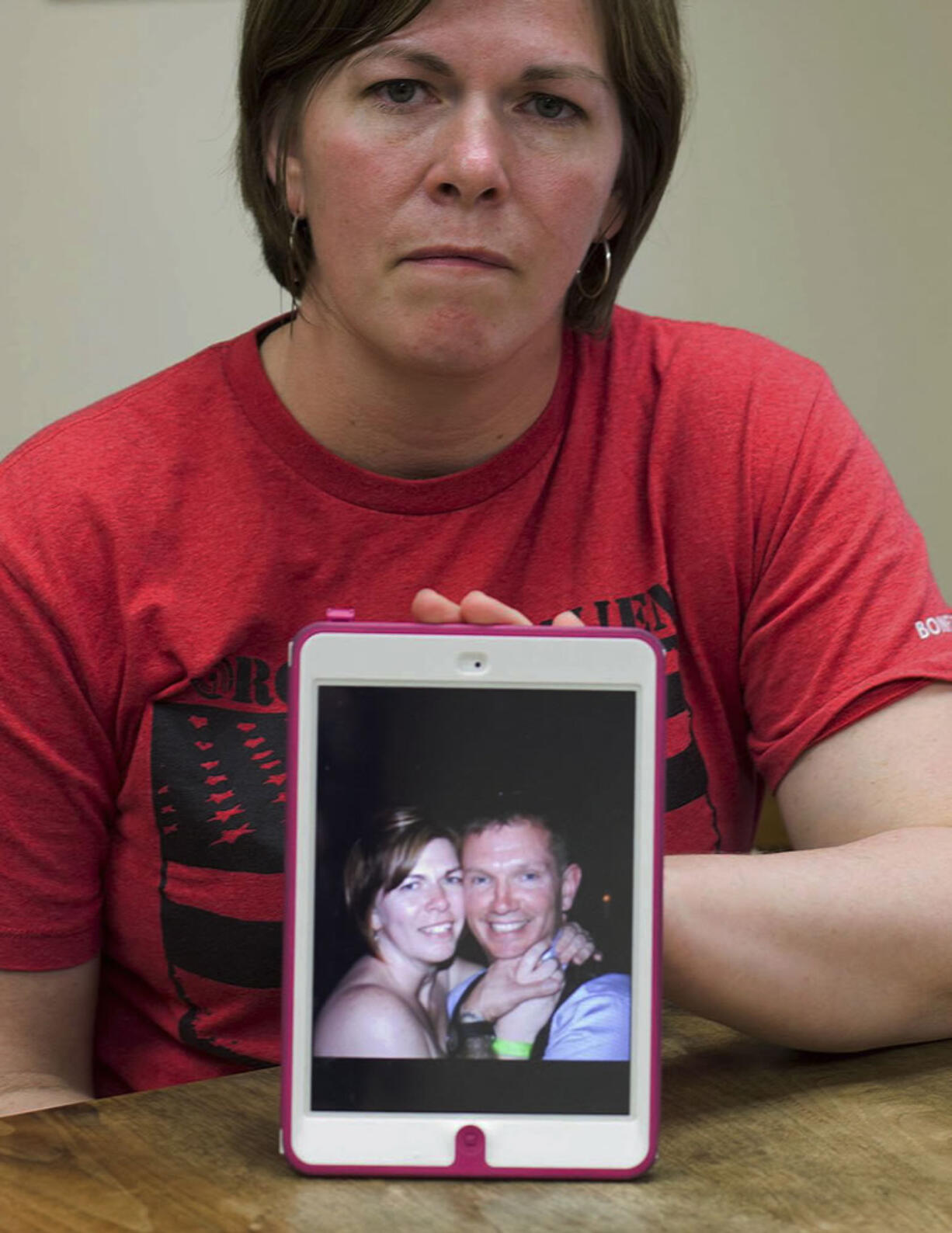 Amy Miner, of Essex, Vt., shows an April 2013 photo of herself and her husband, Kryn Miner, an Army veteran who had Post Traumatic Stress Disorder, and who was shot to death by one of their children this April after threatening to kill the family.