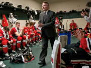 Head Coach Mike Johnston finishes a pre-game talk before his team takes the ice against Everett on Sunday January 26, 2014.