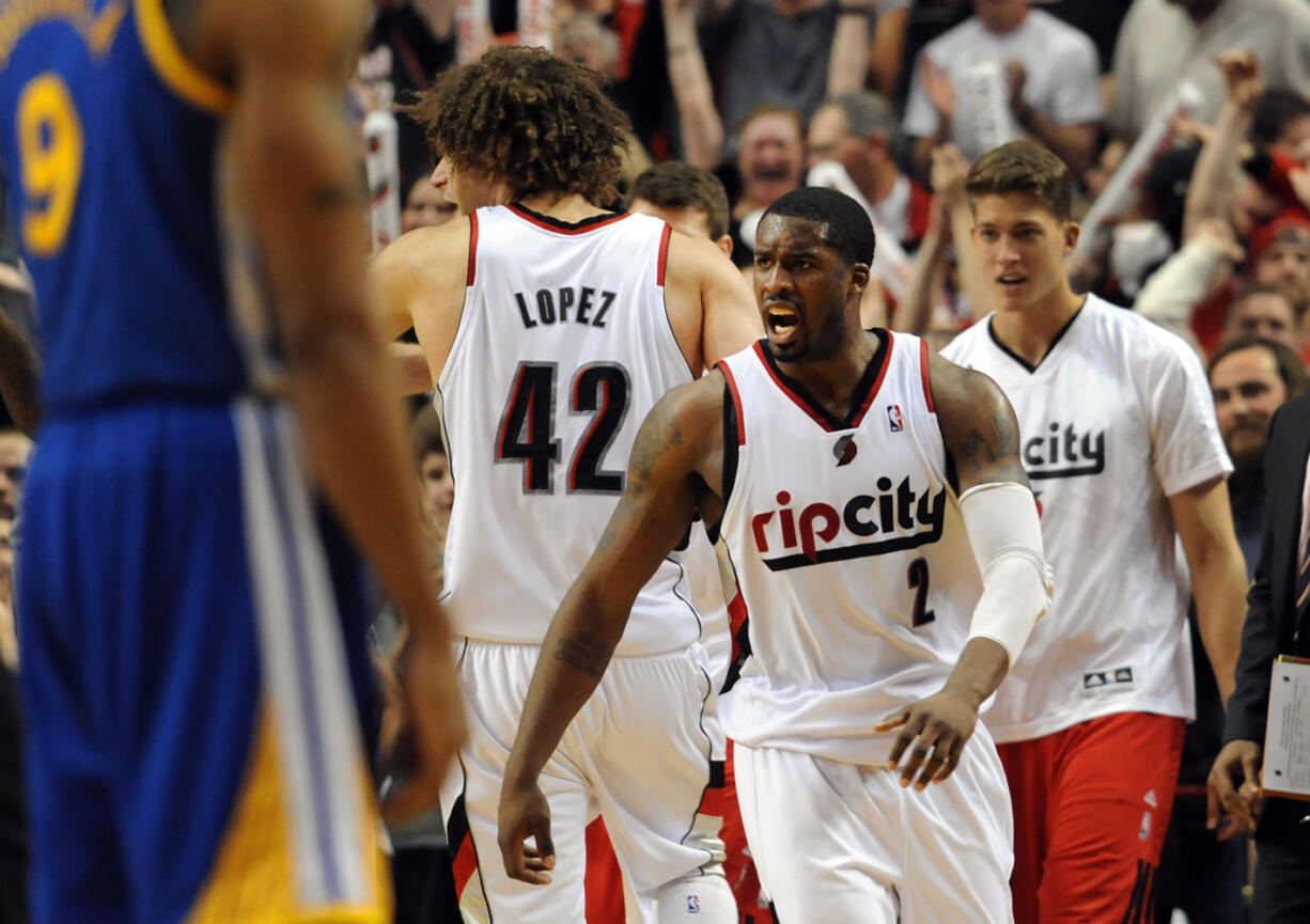 Portland Trail Blazers guard Wesley Matthews (2) celebrates with Portland Trail Blazers center Robin Lopez (42) at the end of an overtime NBA basketball game against the Golden State Warriors in Portland, Ore., Sunday, April 13, 2014. The Blazers won the game 119-117.