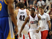 Portland Trail Blazers guard Wesley Matthews (2) celebrates with Portland Trail Blazers center Robin Lopez (42) at the end of an overtime NBA basketball game against the Golden State Warriors in Portland, Ore., Sunday, April 13, 2014. The Blazers won the game 119-117.