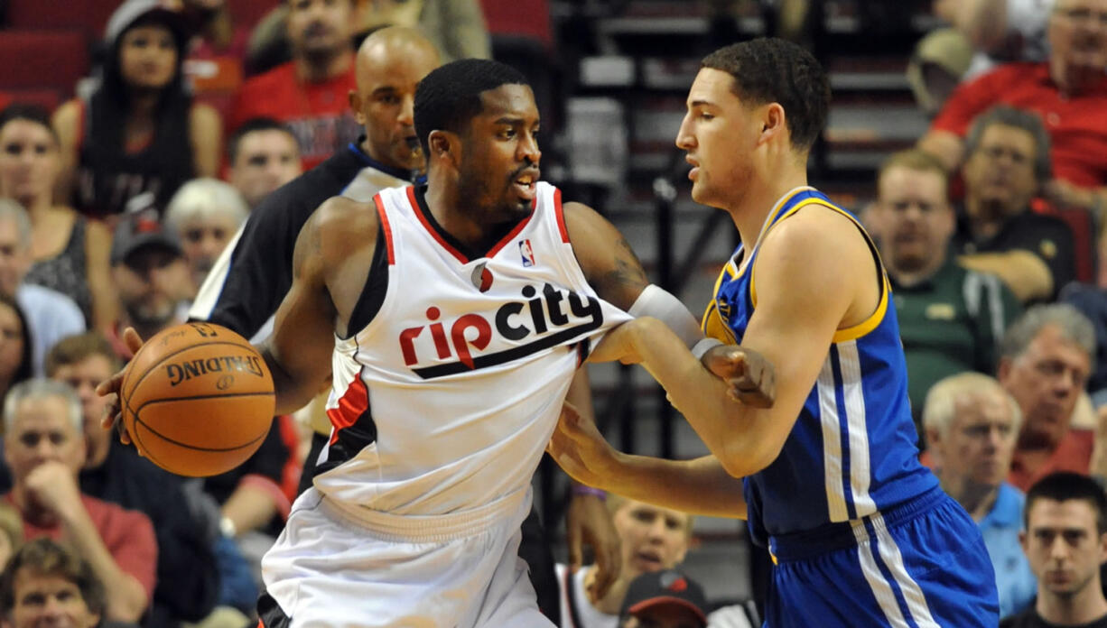 Golden State Warriors guard Klay Thompson (11) defends as Portland Trail Blazers guard Wesley Matthews (2) makes a move to the basket during the first half Sunday at the Moda Center.