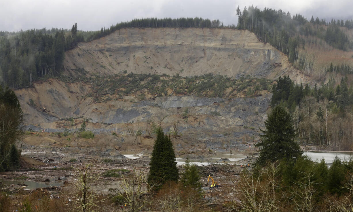 The massive mudslide that struck last Saturday near Darrington is seen as viewed from a ridge Thursday.