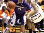 Washington guard Nigel Williams-Goss, left, drives to the hoop past Oregon State guard Hallice  Cooke during the first half Saturday. Williams-Goss had 14 points and 10 assists in the Huskies' 86-62 victory.