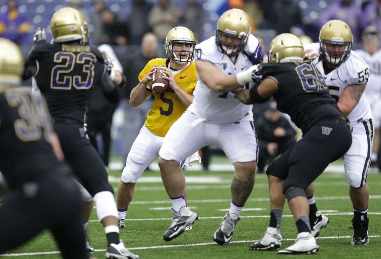 Washington quarterback Jeff Lindquist (5) drops back to pass on Saturday, April 19, 2014, during the team's spring NCAA college football game in Seattle. (AP Photo/Ted S.