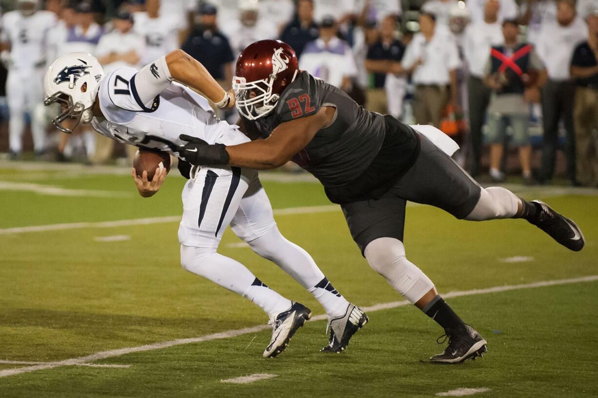 Washington State's Robert Barber (92) sacks Nevada's Cody Fajardo (17) during the first half Friday in Reno, Nev.