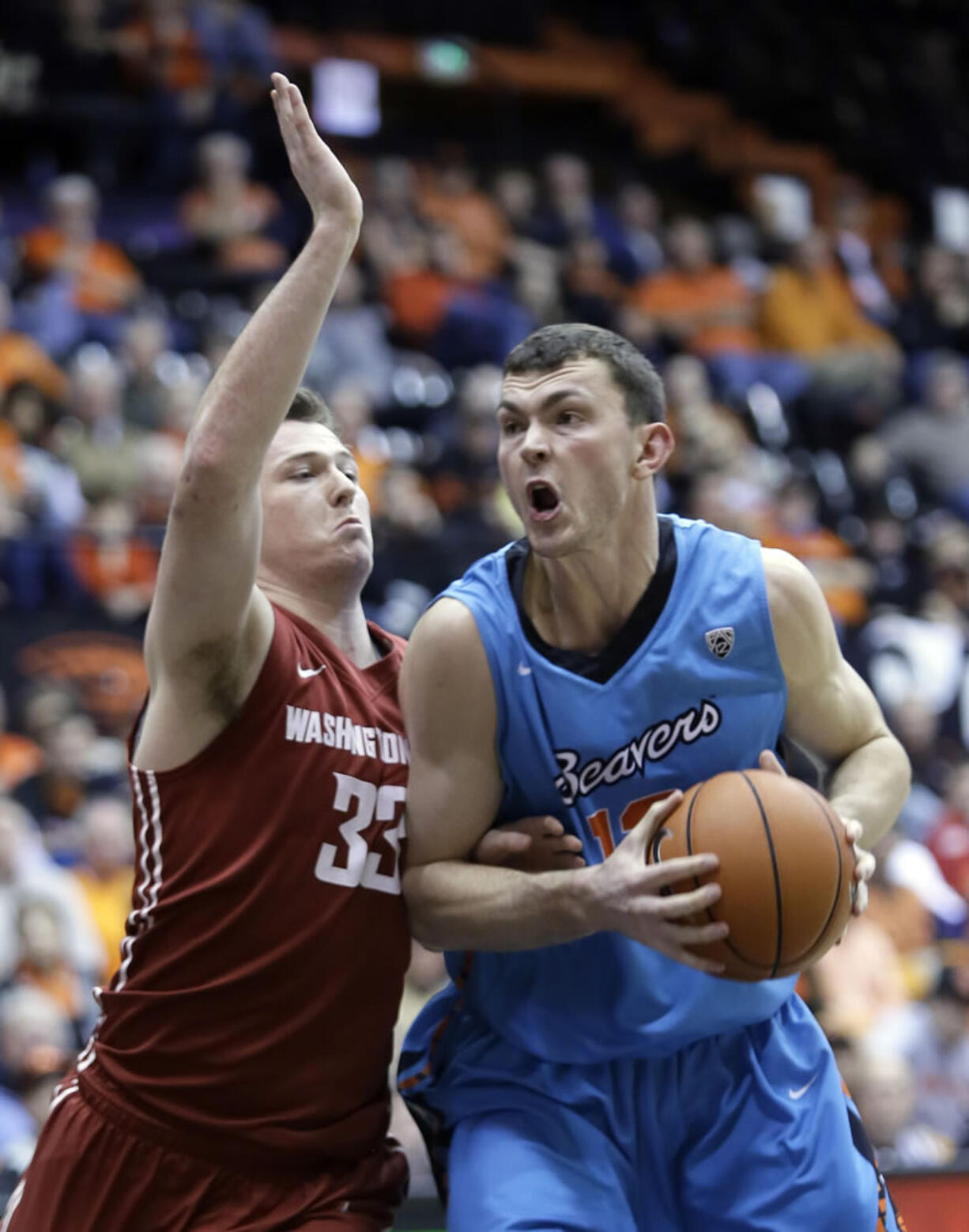 Oregon State center Angus Brandt drives to the basket against Washington State forward Brett Boese during the second half Thursday. Brandt led Oregon State in scoring with 16 points as they defeated Washington State 68-57.