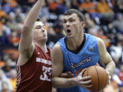 Oregon State center Angus Brandt drives to the basket against Washington State forward Brett Boese during the second half Thursday. Brandt led Oregon State in scoring with 16 points as they defeated Washington State 68-57.