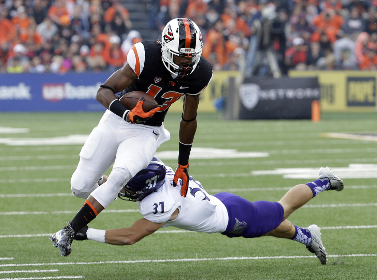 Oregon State wide receiver Jordan Villamin, left, is pursued by Weber State's Mitch Tulane during the first half Friday, Sept. 4, 2015, in Corvallis, Ore.