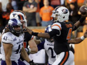 Oregon State quarterback Seth Collins, right, throws as Weber State defensive lineman Jonathan Carlson watches during the second half of an NCAA college football in Corvallis, Ore., Friday, Sept. 4, 2015. Oregon State won 26-7.