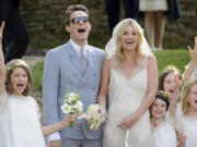 Assocaited Press files
British model Kate Moss and British guitarist Jamie Hince pose for photos with bridesmaids after their July 2011 wedding in Southrop, England.