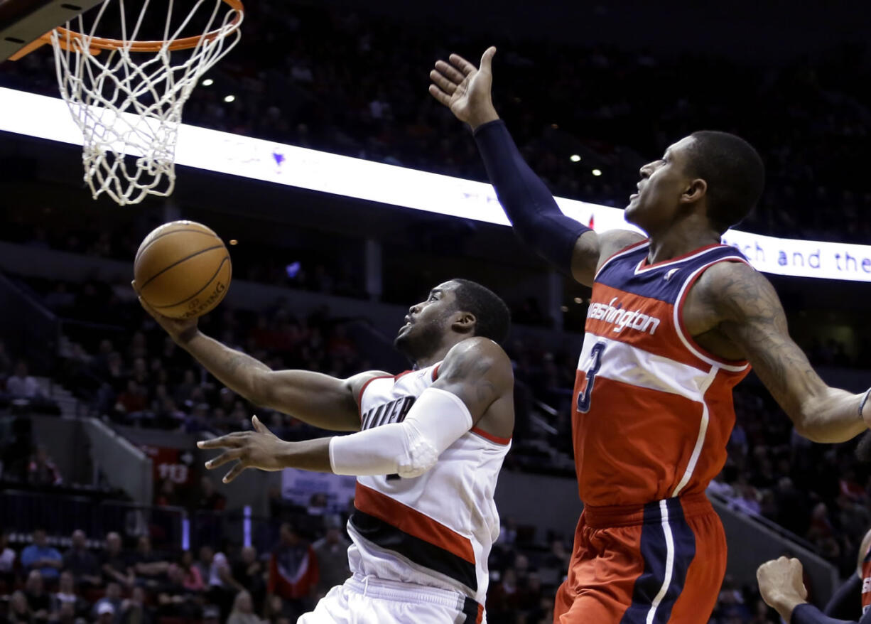 Portland Trail Blazers guard Wesley Matthews, left, drives to the basket past Washington Wizards guard Bradley Beal during the second half Thursday. Matthews led the Trail Blazers with 28 points as they won 116-103.