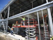 Construction workers with Harlen's Drywall of Vancouver install galvanized metal framing at a medical building under construction in Salmon Creek on June 3.