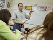 Hewlett-Packard employee and STEM volunteer John Sturman helps students with AP calculus at Union High School in November.