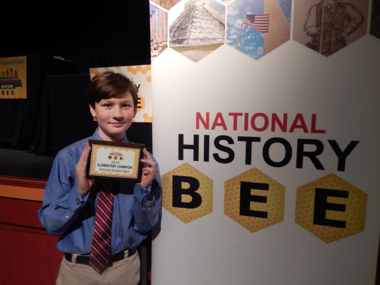 Eisenhower Elementary fifth-grader Andrew Douglas holds his award for winning the regional championship of the National History Bee.