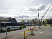 With the help of the Vancouver Fire Department's ladder truck, police investigate a fatal accident involving a C-Tran bus and a bicyclist in April 2012.