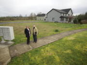 Tracie Jellison, left, and Bernard Stea stand next to undeveloped lots in the Stoneleaf neighborhood where they live in Camas.