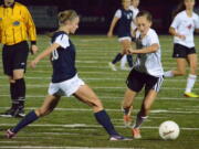 Camas midfielder Sabine Postma is challenged by Skyview defender Becca Harris during a 4A Greater St. Helens League soccer match Tuesday in Camas.