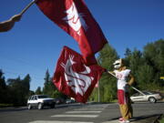 Washington State University mascot Butch T. Cougar greets traffic coming onto the Salmon Creek campus this morning.