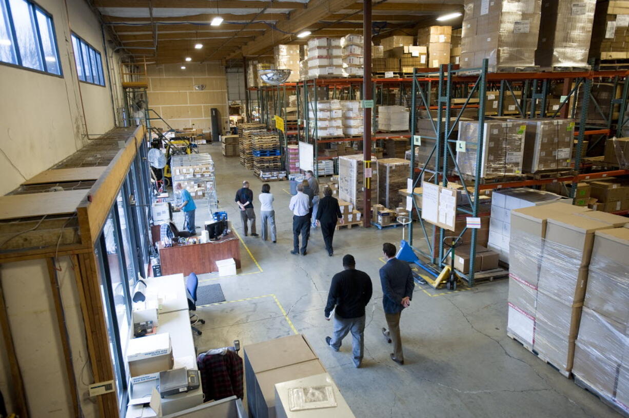 Local economic development officials including Vancouver Mayor Tim Leavitt, tour the First Aid Only company headquarters in Vancouver in January 2012.