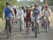 In this Columbian file photo from summer 2013, Arnada neighborhood resident Todd Bachmann, left, and Vancouver Mayor Tim Leavitt lead a bike rally to publicize the need for safer cycling along Lower River Road.