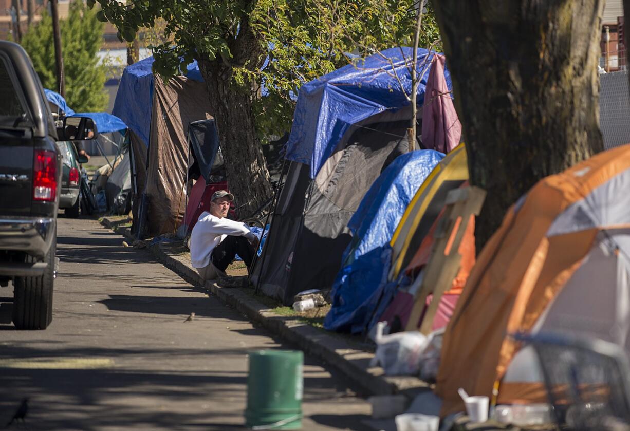 Dozens of tents line West 12th Street on Monday afternoon in downtown Vancouver. City officials said they've never seen this many homeless campers in the area before.