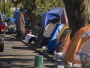 Dozens of tents line West 12th Street on Monday afternoon in downtown Vancouver. City officials said they've never seen this many homeless campers in the area before.