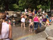 Scenes like this one from May 1, with area children and some adults cooling off in the water at Esther Short Park in downtown Vancouver, may be repeated over the next week as an extended heat wave blankets the region.