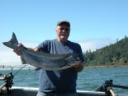 Gary Baker of Olympia with a small fall chinook salmon caught near the Astoria Bridge at Buoy 10.