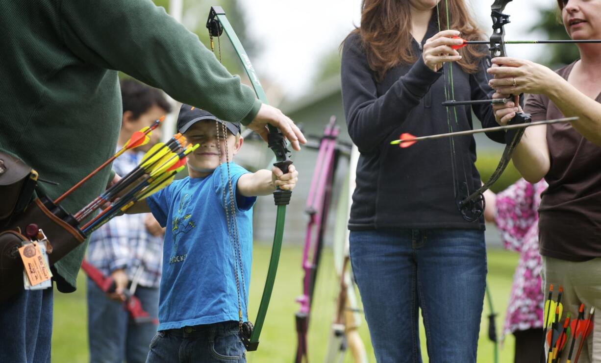 Steven Lane/Columbian files
Tyler Miles, 5, from Vancouver, fires an arrow from a bow for the first time at the Get Outdoors Day event at Fort Vancouver.