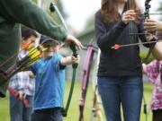 Steven Lane/Columbian files
Tyler Miles, 5, from Vancouver, fires an arrow from a bow for the first time at the Get Outdoors Day event at Fort Vancouver.