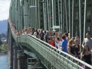 Thousands gather on the pedestrian sidewalk of the Interstate 5 Bridge on Sept. 2, 2013, joining hands and cheering their recovery from drug addiction. The 12th annual Hands Across the Bridge event marked the beginning of National Recovery Month. Hands Across the Bridge will be on Sept.