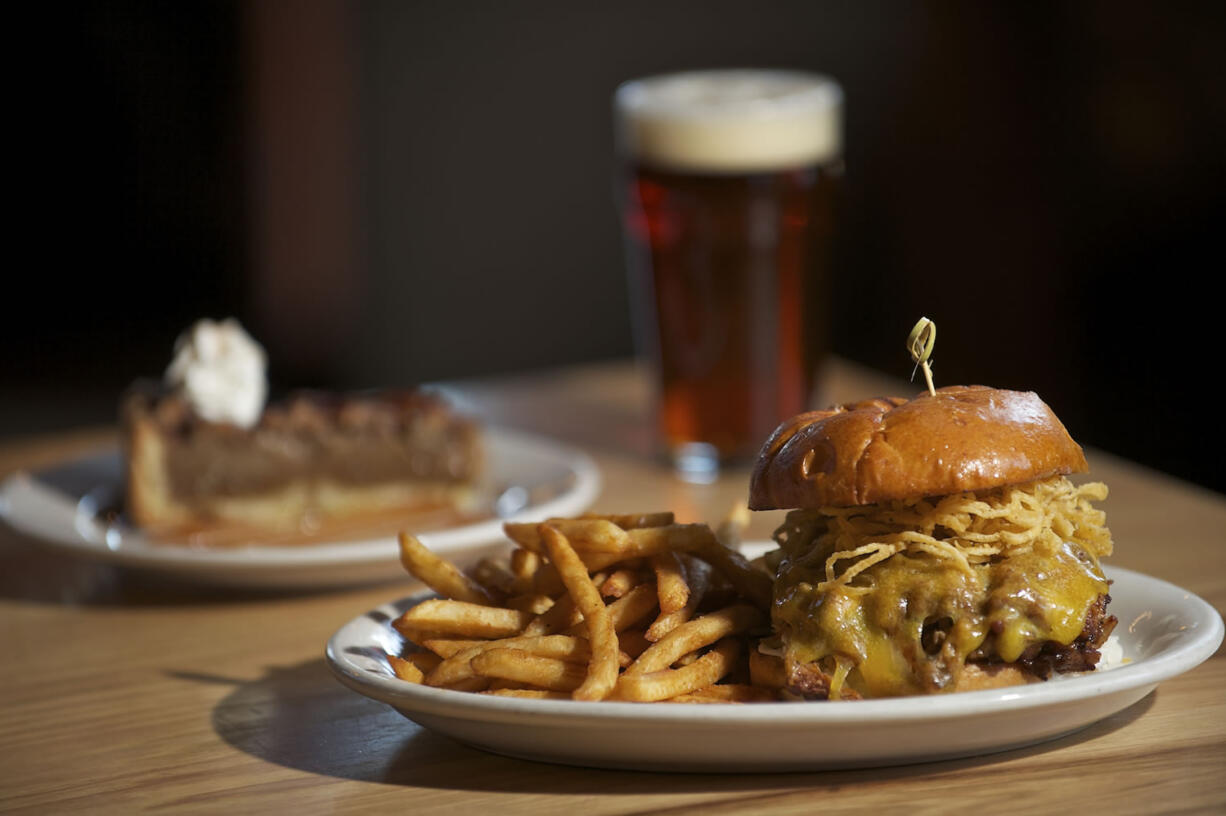 The pulled pork sandwich, foreground, and Kentucky bourbon pecan pie shown March 21 at Northwood restaurant in Battle Ground.