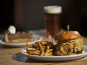 The pulled pork sandwich, foreground, and Kentucky bourbon pecan pie shown March 21 at Northwood restaurant in Battle Ground.