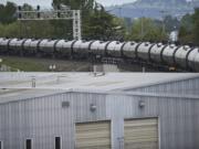 A train with tanker cars passes through downtown Vancouver on Friday.(Zachary Kaufman/The Columbian)