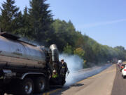 Asphalt workers resurface a section of La Center Road on Saturday.