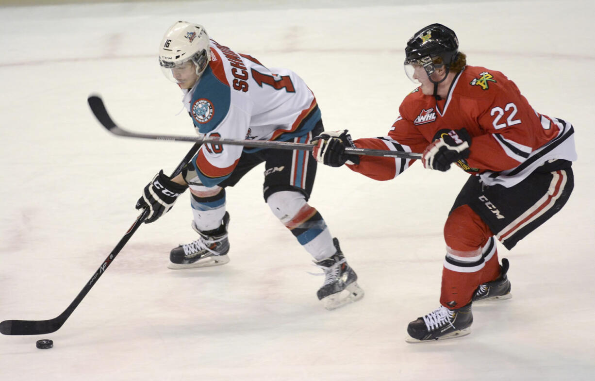 Kelowna Rockets' Kris Schmidli battles for the puck along with Portland Winterhawks Alex Schoenborn during WHL playoff action at Prospera Place on Friday.