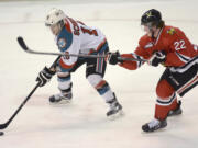 Kelowna Rockets' Kris Schmidli battles for the puck along with Portland Winterhawks Alex Schoenborn during WHL playoff action at Prospera Place on Friday.