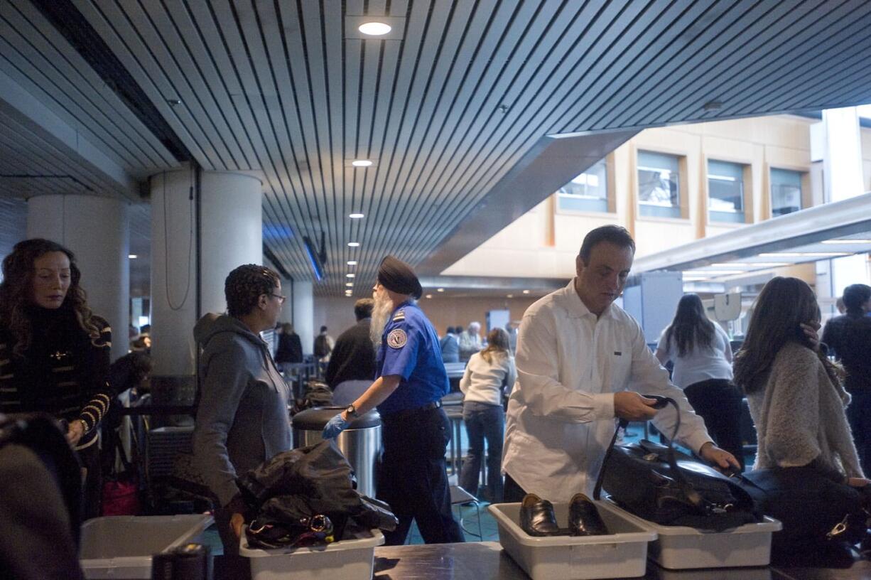 Passengers prepare to navigate through the security checkpoint at Portland International Airport.