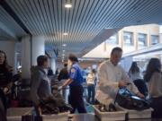 Passengers prepare to navigate through the security checkpoint at Portland International Airport.