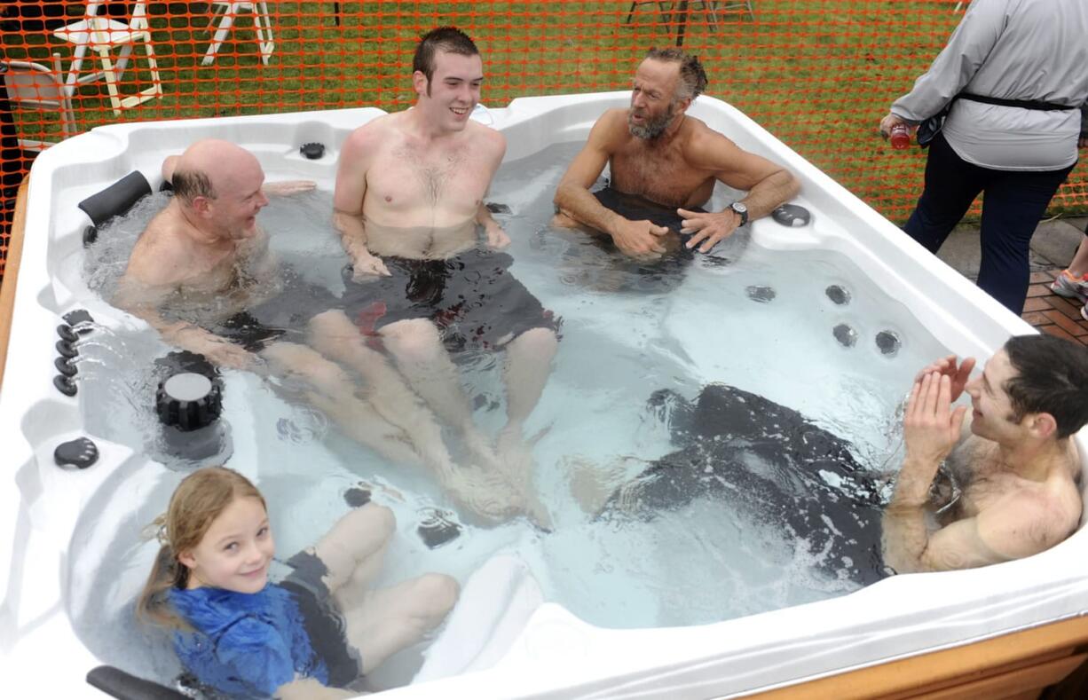 Resolution Run
Resolution Run participants, clockwise from bottom left, Olivia Easter, Joe and Charlie Quinn, Kevin Edwards and Curtis Roth warm up Sunday in a hot tub -- the reward for braving the post-run Polar Bear Slide at the Battle Ground Village shopping complex.
Photos by Greg Wahl-Stephens for The Columbian