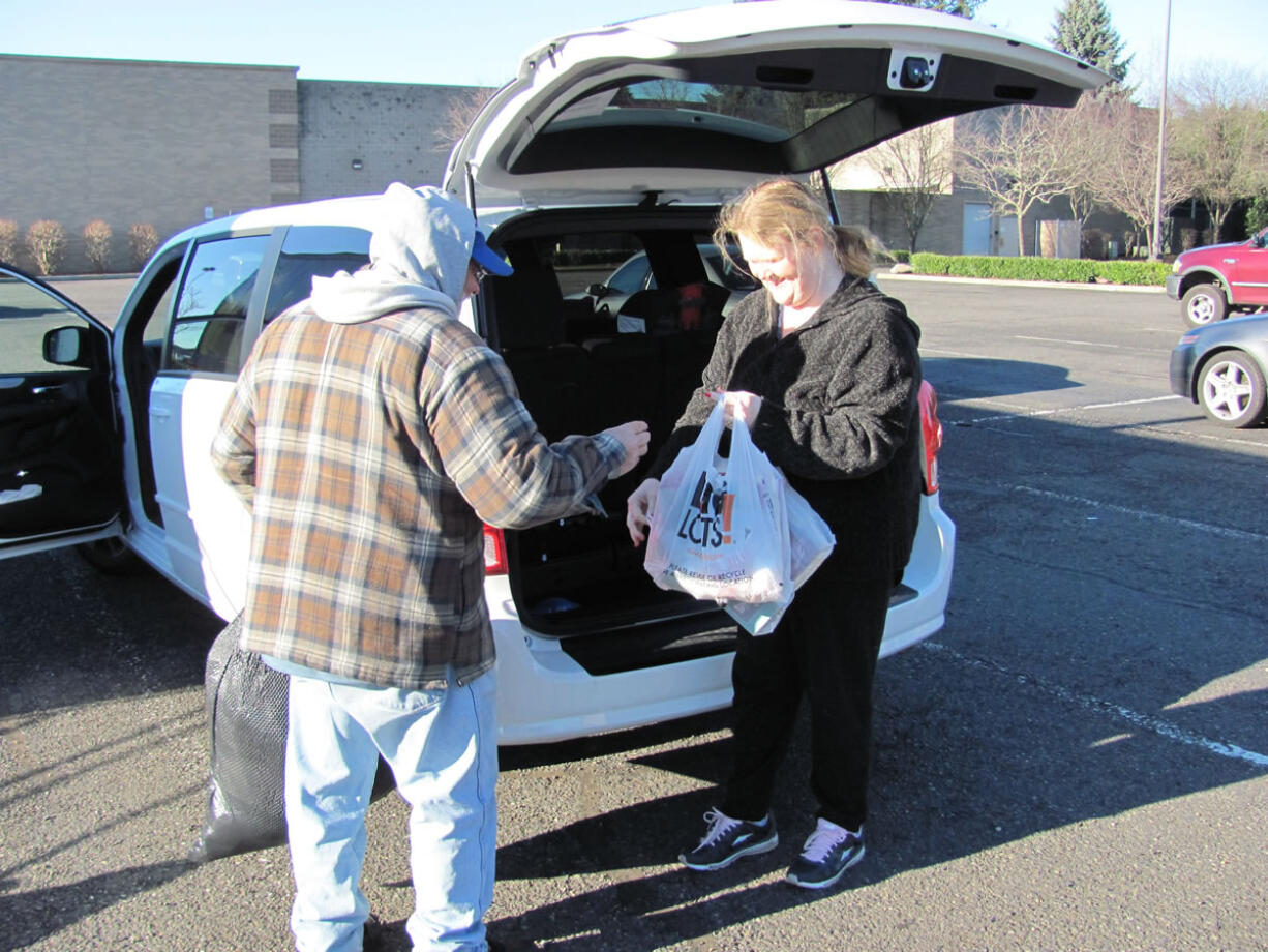 Kevin Shaw, a donation attendant for Goodwill Industries, accepts contributed items, in the Evergreen Marketplace, in Washougal.