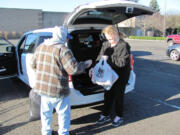 Kevin Shaw, a donation attendant for Goodwill Industries, accepts contributed items, in the Evergreen Marketplace, in Washougal.