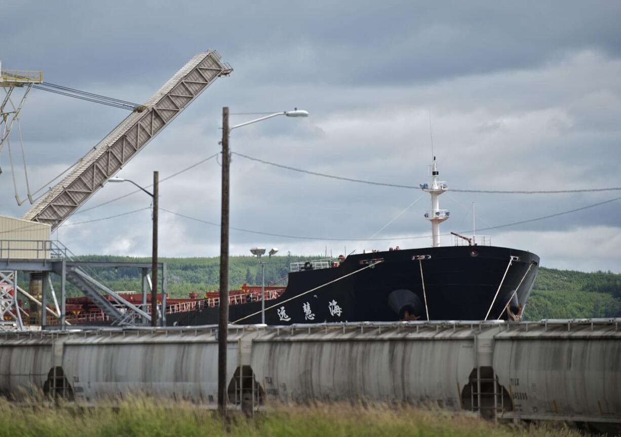 A Chinese cargo ship loads soy beans next to the Imperium site in Hoquiam, one of three proposed oil terminal sites in Grays Harbor County.