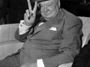 British Prime Minister Winston Churchill responds with the &quot;V&quot; for victory sign he made a trademark during World War II as spectators cheer his arrival at National Airport in Washington, D.C., June 25, 1954.