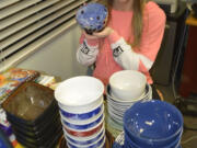 McKenzie Kitchen holds one of the many bowls that will be given to those attending a soup dinner fund raiser at Excelsior High School.