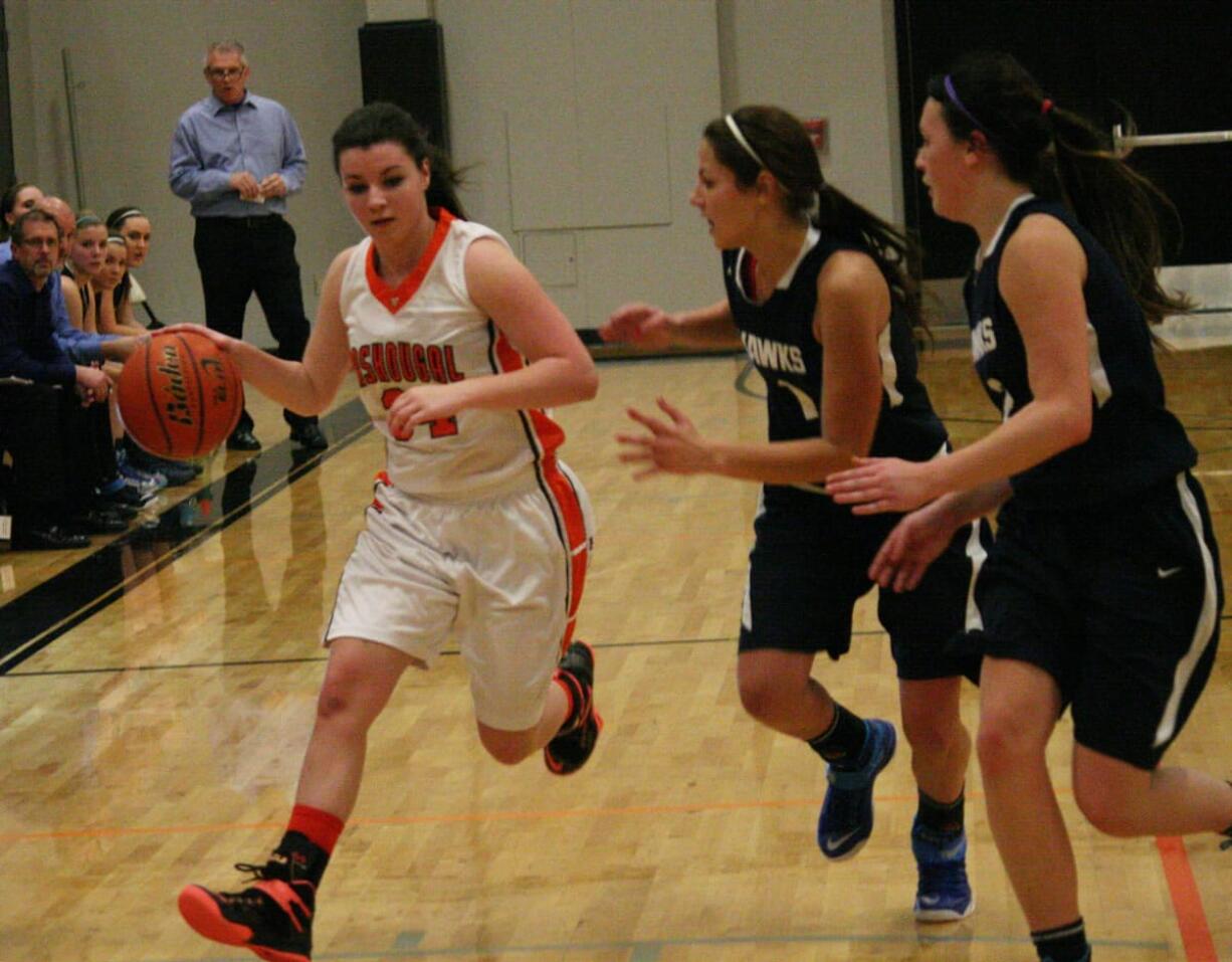 Alyssa Blankenship dribbles the basketball by two Hockinson Hawks Friday, at Washougal High School.