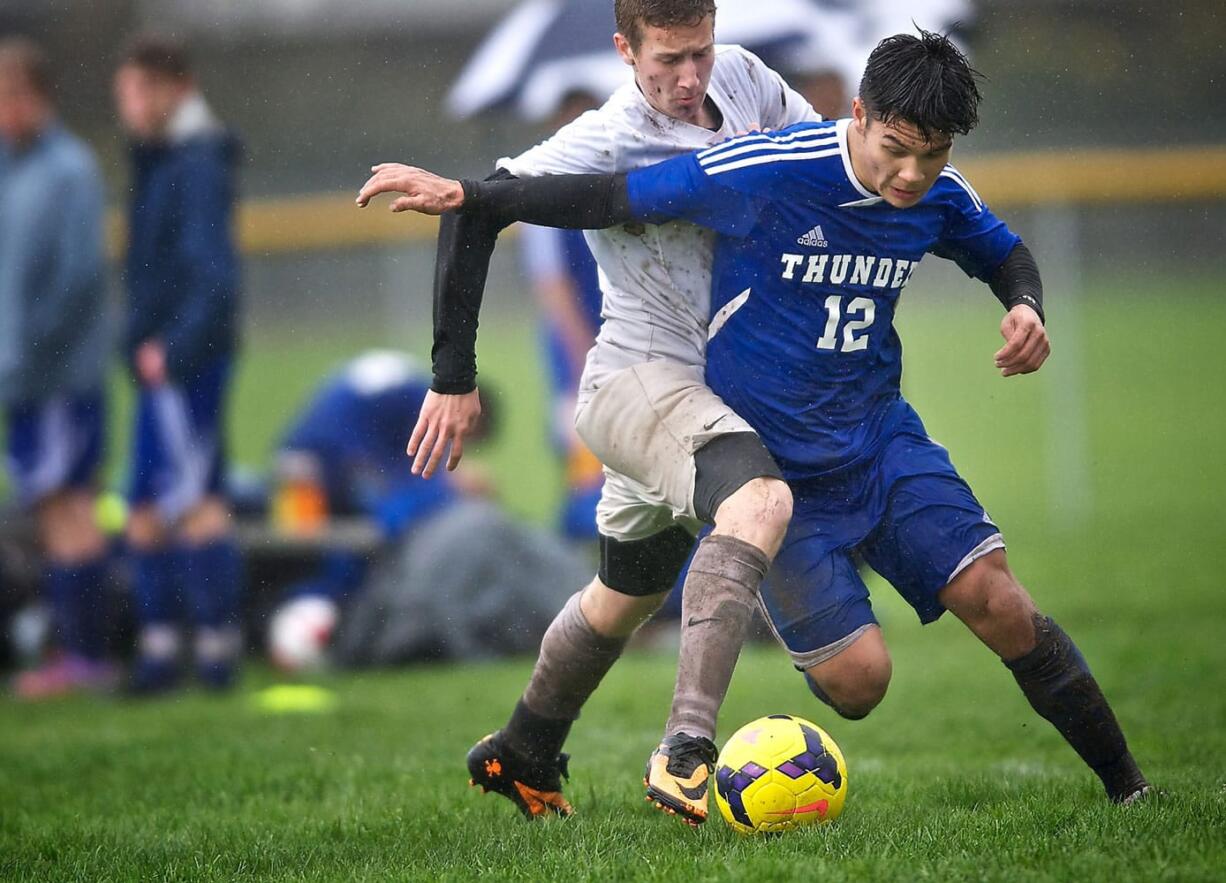 Mountain View's Isaac Strever (12), battling against Heritage High's Grant Thiriot in Friday's match, has six goals and two assists six games into the season.